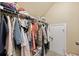 Walk-in closet with clothes hanging on a rack with a shelf above the rack for additional storage at 5149 Morning Frost Pl., Myrtle Beach, SC 29579