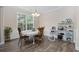 Dining room featuring a white table with seating for four, a chandelier, and a large window providing natural light at 5149 Morning Frost Pl., Myrtle Beach, SC 29579