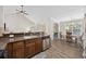 Open concept kitchen featuring stainless steel appliances, dark wood cabinetry, and breakfast bar at 5149 Morning Frost Pl., Myrtle Beach, SC 29579