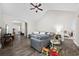 Spacious living room with hardwood floors, high ceiling, ceiling fan and a large gray sectional couch at 5149 Morning Frost Pl., Myrtle Beach, SC 29579