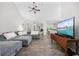 Spacious living room featuring a large sectional sofa, hardwood floors, high ceiling, and a ceiling fan at 5149 Morning Frost Pl., Myrtle Beach, SC 29579
