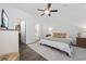Bright main bedroom features a ceiling fan and ensuite bathroom, providing a comfortable retreat at 5149 Morning Frost Pl., Myrtle Beach, SC 29579