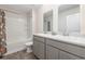 A bright bathroom featuring a large mirror above double sinks and a shower/tub combination at 555 Strawberry Field Way, Galivants Ferry, SC 29544