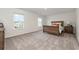 Inviting bedroom featuring a wooden bed frame, soft carpet, and natural light at 555 Strawberry Field Way, Galivants Ferry, SC 29544
