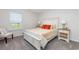 This well-lit bedroom has a white wooden bed frame with matching end tables and carpeted floors at 555 Strawberry Field Way, Galivants Ferry, SC 29544