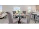 Stylish dining area featuring a glass-top table with four chairs, set with plates and cups at 555 Strawberry Field Way, Galivants Ferry, SC 29544