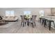 Cozy dining area with glass table and seating for four, blending into a modern living space at 555 Strawberry Field Way, Galivants Ferry, SC 29544