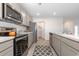 Bright kitchen features a modern refrigerator, stainless steel appliances, and grey cabinets at 555 Strawberry Field Way, Galivants Ferry, SC 29544