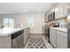 Well-lit kitchen featuring stainless steel appliances, light gray cabinetry, and hardwood flooring at 555 Strawberry Field Way, Galivants Ferry, SC 29544