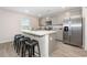 Modern kitchen with gray cabinets, stainless steel appliances, and a large island with bar stool seating at 555 Strawberry Field Way, Galivants Ferry, SC 29544