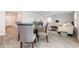 Open concept living and dining room with hard surface flooring and modern furnishings at 555 Strawberry Field Way, Galivants Ferry, SC 29544