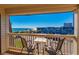 Relaxing balcony view with seating, overlooking the ocean, beach, and parking area on a clear day at 5601 N Ocean Blvd. # C-314, Myrtle Beach, SC 29577