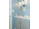 Stylish vanity with sink, modern fixtures, and a round mirror in a well-lit bathroom at 5601 N Ocean Blvd. # C-314, Myrtle Beach, SC 29577