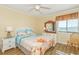 Cozy bedroom with ocean-themed decor, a comfortable bed, and lots of natural light at 5601 N Ocean Blvd. # C-314, Myrtle Beach, SC 29577