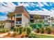 Beautiful exterior of a condo building with palm trees and manicured landscaping on a sunny day at 5601 N Ocean Blvd. # C-314, Myrtle Beach, SC 29577