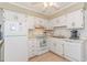 Kitchen featuring white appliances and cabinets, complemented by tile floors and neutral walls at 5601 N Ocean Blvd. # C-314, Myrtle Beach, SC 29577