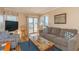 Comfortable living room featuring a couch, television, and a view to the outdoor balcony at 5601 N Ocean Blvd. # C-314, Myrtle Beach, SC 29577