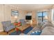 Inviting living room offers comfortable seating and an open view to the outdoor balcony at 5601 N Ocean Blvd. # C-314, Myrtle Beach, SC 29577