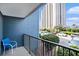 Cozy balcony view with blue siding and a peek of the parking area and towering condo building at 5905 South Kings Hwy. # 132B, Myrtle Beach, SC 29575