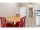 Cozy dining area with wooden table and red chairs next to the kitchen at 5905 South Kings Hwy. # 132B, Myrtle Beach, SC 29575
