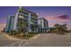 Image of the condominium complex entrance showcasing well maintained landscaping and covered entry at 5905 South Kings Hwy. # 132B, Myrtle Beach, SC 29575