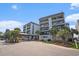 Attractive exterior view of a well-maintained condo complex with lush landscaping and covered entrance at 5905 South Kings Hwy. # 132B, Myrtle Beach, SC 29575