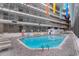 Spacious indoor pool area featuring multiple lounging areas, a hot tub, and ample seating for residents at 5905 South Kings Hwy. # 132B, Myrtle Beach, SC 29575