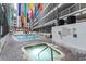 Inviting indoor pool and hot tub area with colorful banners and ample lounging space at 5905 South Kings Hwy. # 132B, Myrtle Beach, SC 29575