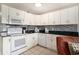 Bright kitchen featuring white cabinetry, stainless steel appliances, and stylish backsplash at 5905 South Kings Hwy. # 132B, Myrtle Beach, SC 29575