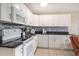 Bright kitchen featuring white cabinetry, stainless steel appliances, and stylish backsplash at 5905 South Kings Hwy. # 132B, Myrtle Beach, SC 29575
