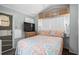 Cozy bedroom with a full-size bed, TV, and overhead storage cabinets at 6001 -6010 S Kings Highway, Myrtle Beach, SC 29575