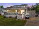 Charming home featuring a spacious front porch, well-maintained lawn, and a convenient golf cart parking area at 6001 -6010 S Kings Highway, Myrtle Beach, SC 29575