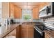 A kitchen featuring granite countertops, wood cabinetry, and stainless steel appliances at 6001 -6010 S Kings Highway, Myrtle Beach, SC 29575