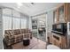Comfortable living room with a cozy couch, television, and sliding glass door access to the outdoor porch area at 6001 -6010 S Kings Highway, Myrtle Beach, SC 29575