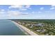 Picturesque aerial view of a beachfront community with a sandy beach, oceanfront condos, and lush vegetation at 601 Retreat Beach Circle # 213, Pawleys Island, SC 29585