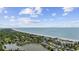 Expansive aerial view showcasing a coastline with waterfront properties and breathtaking ocean vistas under a partly cloudy sky at 601 Retreat Beach Circle # 213, Pawleys Island, SC 29585
