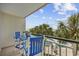 Balcony with seating features views of the pool, palm trees, and the ocean at 601 Retreat Beach Circle # 213, Pawleys Island, SC 29585