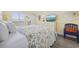 Cozy bedroom with white furniture, a TV, and a door to the outside at 601 Retreat Beach Circle # 213, Pawleys Island, SC 29585