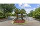 Community entrance with palm trees, flowers, and a security gate at 601 Retreat Beach Circle # 213, Pawleys Island, SC 29585