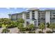 An inviting entryway is flanked by tropical landscaping and covered access to upper level residences at 601 Retreat Beach Circle # 213, Pawleys Island, SC 29585