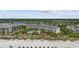 Beachfront resort featuring manicured lawns, palm trees, and inviting pool area, offering a luxurious vacation experience at 601 Retreat Beach Circle # 213, Pawleys Island, SC 29585
