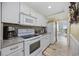 Well-equipped kitchen with white appliances, ample counter space, and a pass-through window at 601 Retreat Beach Circle # 213, Pawleys Island, SC 29585