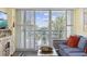 Bright living room featuring a sliding glass door, balcony access and comfortable seating at 601 Retreat Beach Circle # 213, Pawleys Island, SC 29585
