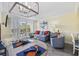 Bright living area with comfortable seating, beachy decor, and access to a balcony with scenic views at 601 Retreat Beach Circle # 213, Pawleys Island, SC 29585