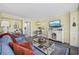 Relaxing living room with a TV, a blue sofa, and a coastal-themed entertainment center at 601 Retreat Beach Circle # 213, Pawleys Island, SC 29585