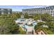 An aerial view of the lazy river and pool area surrounded by lush landscaping and lounging areas at 601 Retreat Beach Circle # 213, Pawleys Island, SC 29585