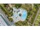 Aerial view of a dynamic pool area featuring a lazy river, water features, and lush landscaping, perfect for relaxation at 601 Retreat Beach Circle # 213, Pawleys Island, SC 29585