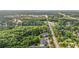 Aerial shot showcases condos nestled among trees, with a road leading to a town in distance at 6016 Dick Pond Rd. # 109, Myrtle Beach, SC 29588
