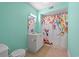 Bright bathroom featuring a floral-themed shower curtain, a vanity with a sink, and a toilet at 6016 Dick Pond Rd. # 109, Myrtle Beach, SC 29588