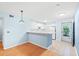 Bright kitchen with white appliances, breakfast bar, tile floors, and plenty of natural light from the glass panel back door at 6016 Dick Pond Rd. # 109, Myrtle Beach, SC 29588